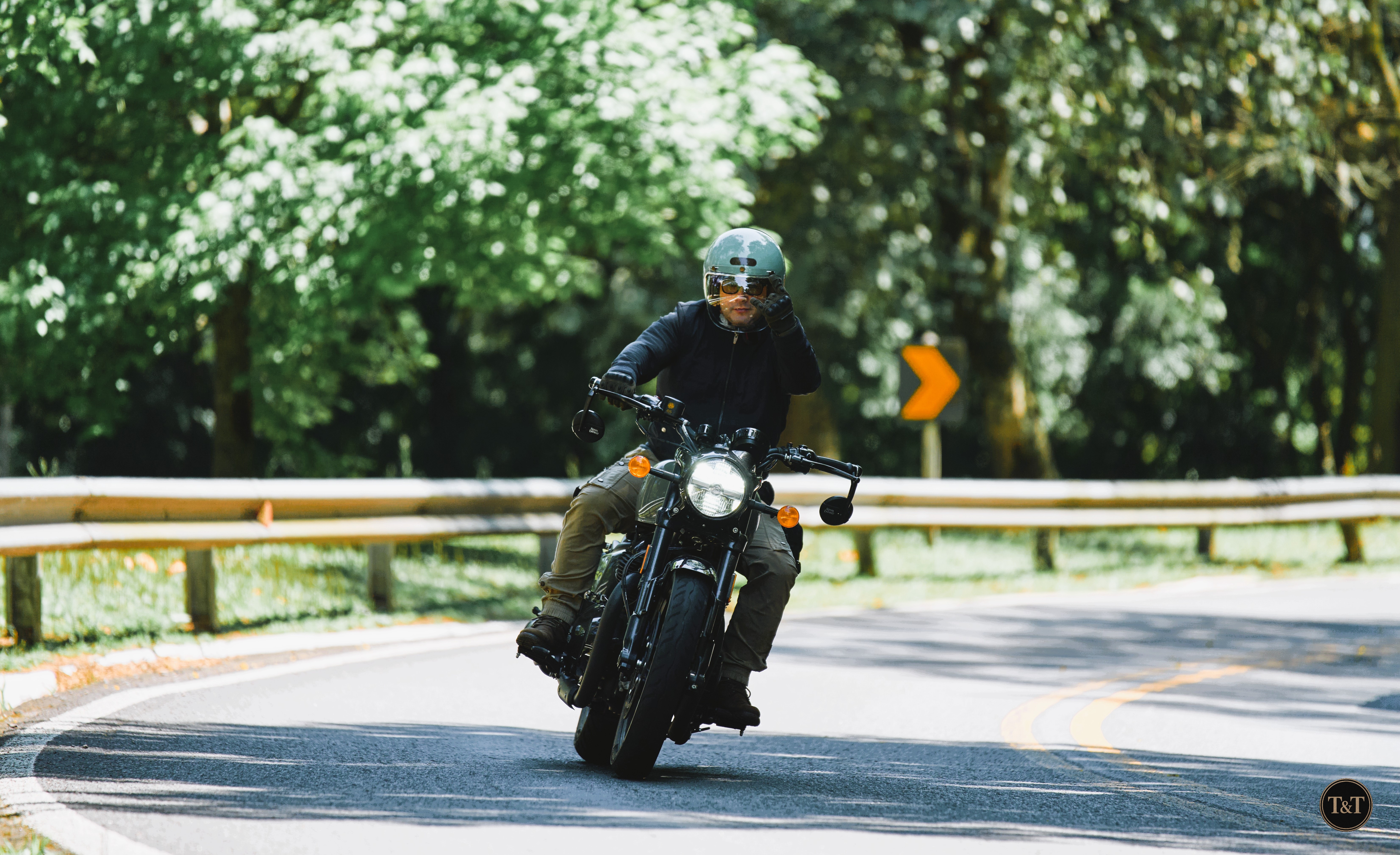Classic motorcyclist overlooking a coastal road